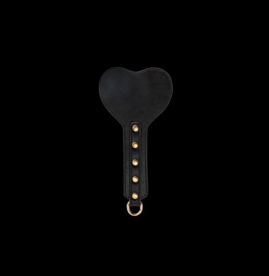 Love Hurts Spanking Paddle with Heart-Shaped Design. A high-quality vegan leather paddle perfect for BDSM play. Features a unique heart-shaped design and is suitable for all levels of play, whether you prefer a gentle spanking or something more intense. Add this essential accessory to your BDSM collection and explore new levels of pleasure.